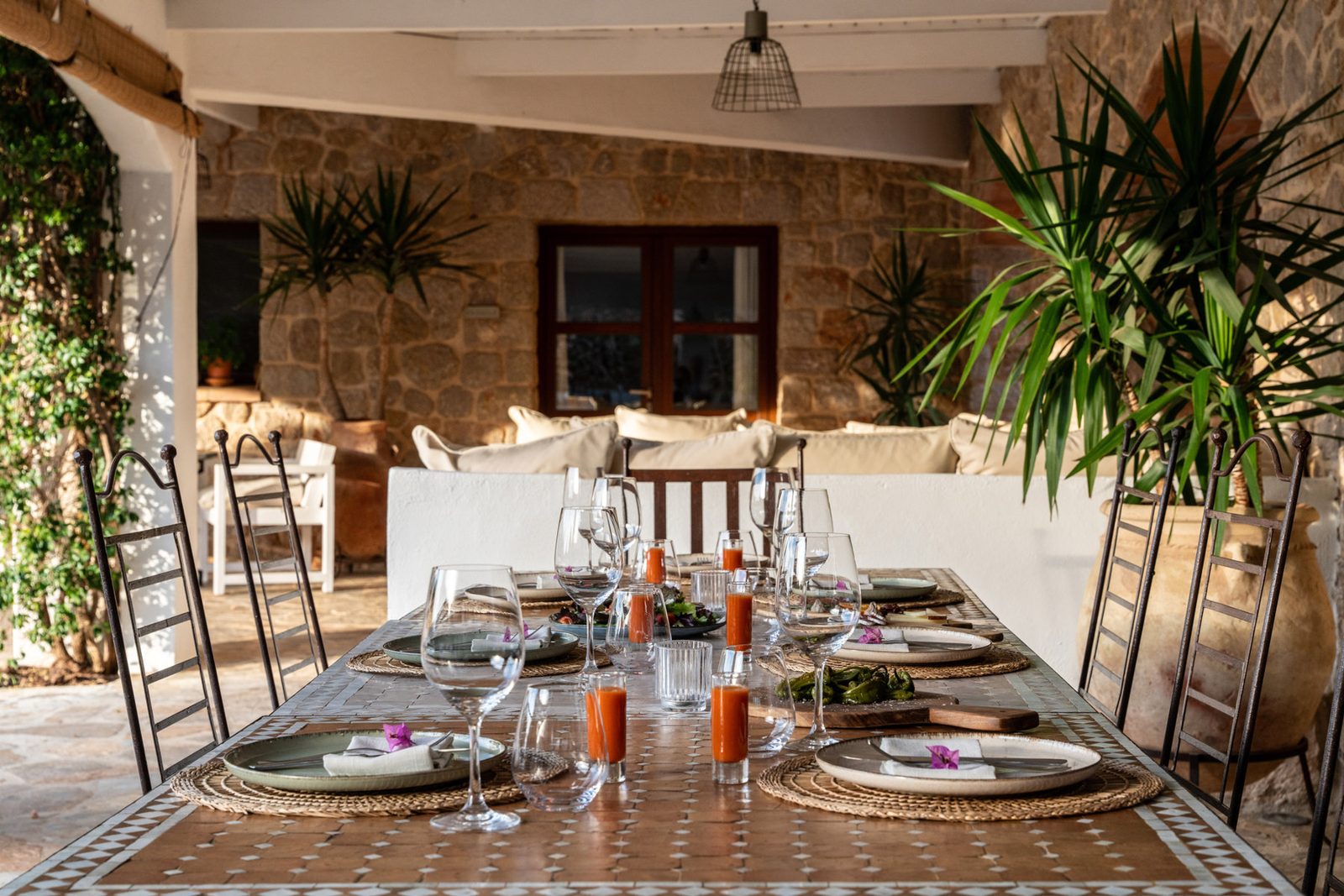 Long dining table laid for a group dinner inside the finca