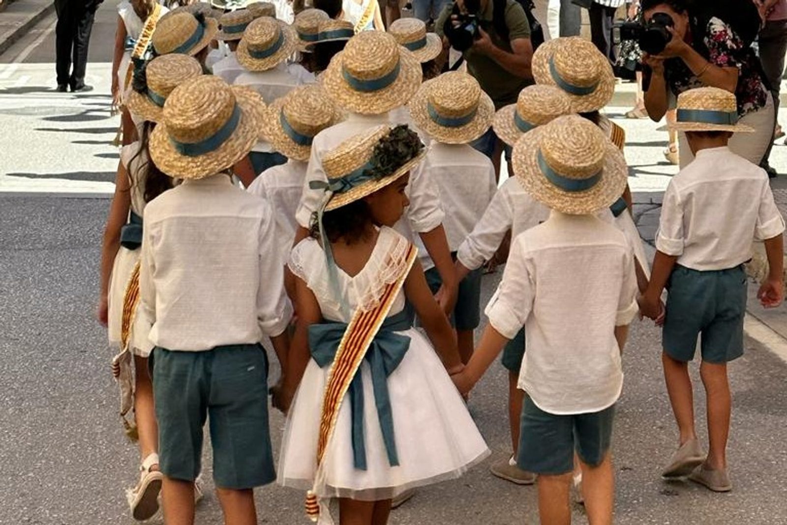 Villagers in traditional straw hats during a Xaló fiesta