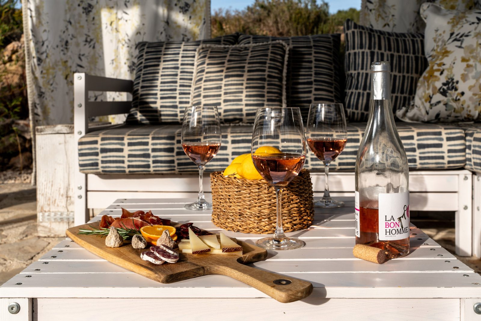 Wine and glasses on a terrace table by the pool